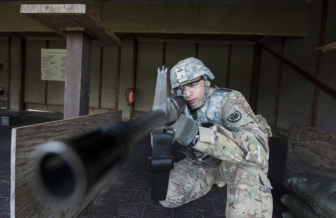 Army Spc. Demel Cooper sights an M16 rifle during a weapons qualification test at a military shooting range in Landstuhl, Germany, Feb. 25, 2016. DoD photo by Air Force Tech. Sgt. Brian Kimball