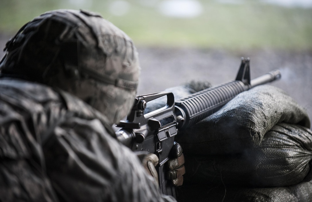 Army Staff Sgt. Esteban Arenas fires an M16 rifle during a weapons qualification test at a military shooting range in Landstuhl, Germany, Feb. 25, 2016. DoD photo by Air Force Tech. Sgt. Brian Kimball