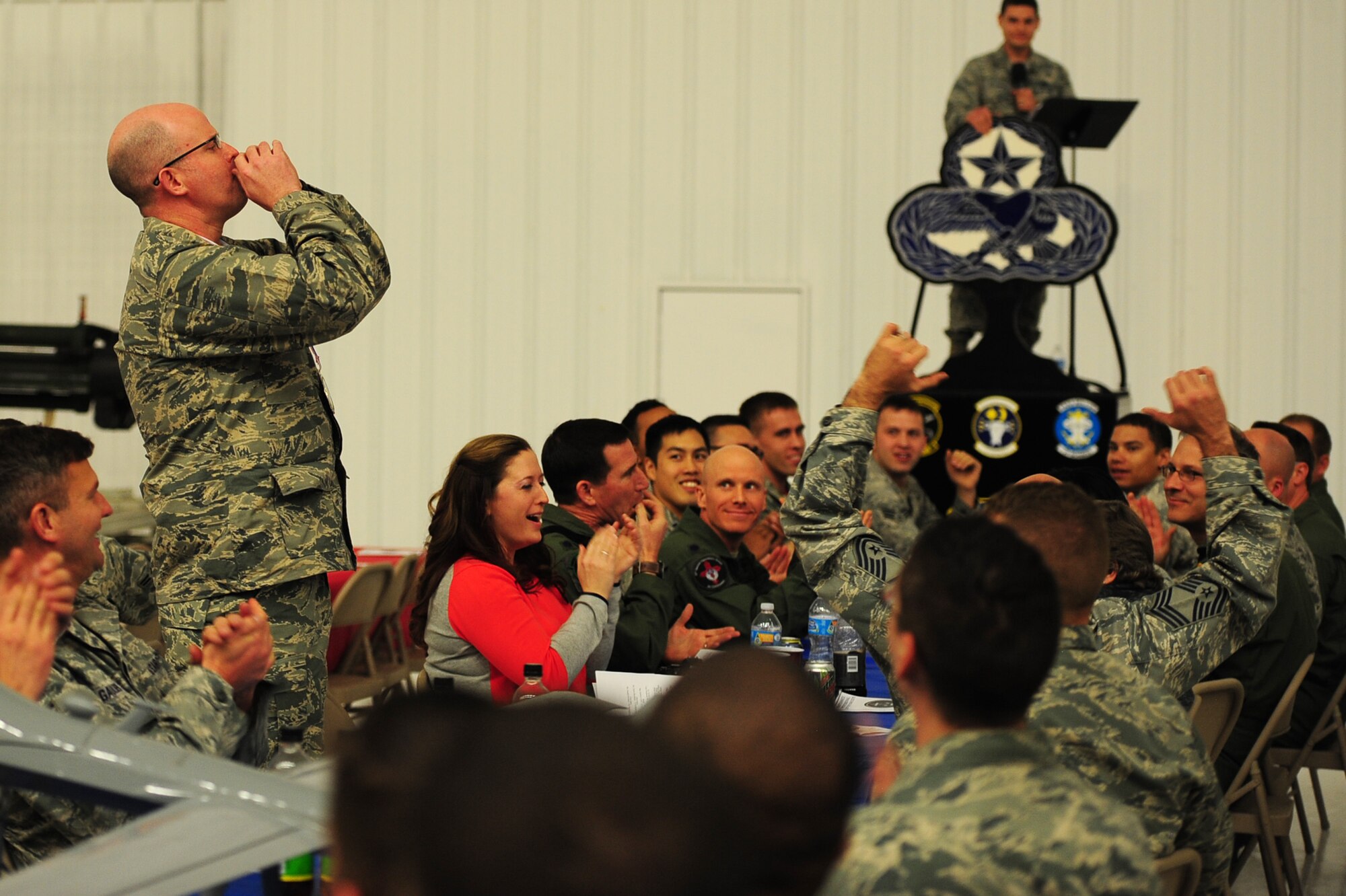 Maintenance leadership calls out to their teammates during a sound-off among the various squadrons in the 27th Special Operations Maintenance Group at the Maintenance Professional of the Year banquet Feb. 26, 2016, at Cannon Air Force Base, N.M. The MPOY banquet is an annual event where all the squadrons within the 27th SOMXG come together to celebrate individual and team achievements. (U.S. Air Force photo/Tech. Sgt. Manuel Martinez)