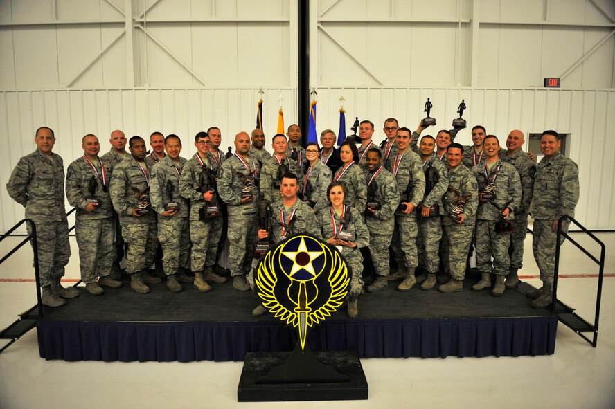 Airmen assigned to the 27th Special Operations Maintenance Group pose for a group photo with their awards and leadership during the Maintenance Professional of the Year banquet Feb. 26, 2016, at Cannon Air Force Base, N.M. The MPOY banquet is an annual event where all the squadrons within the 27th SOMXG come together to celebrate individual and team achievements. (U.S. Air Force photo/Tech. Sgt. Manuel Martinez)