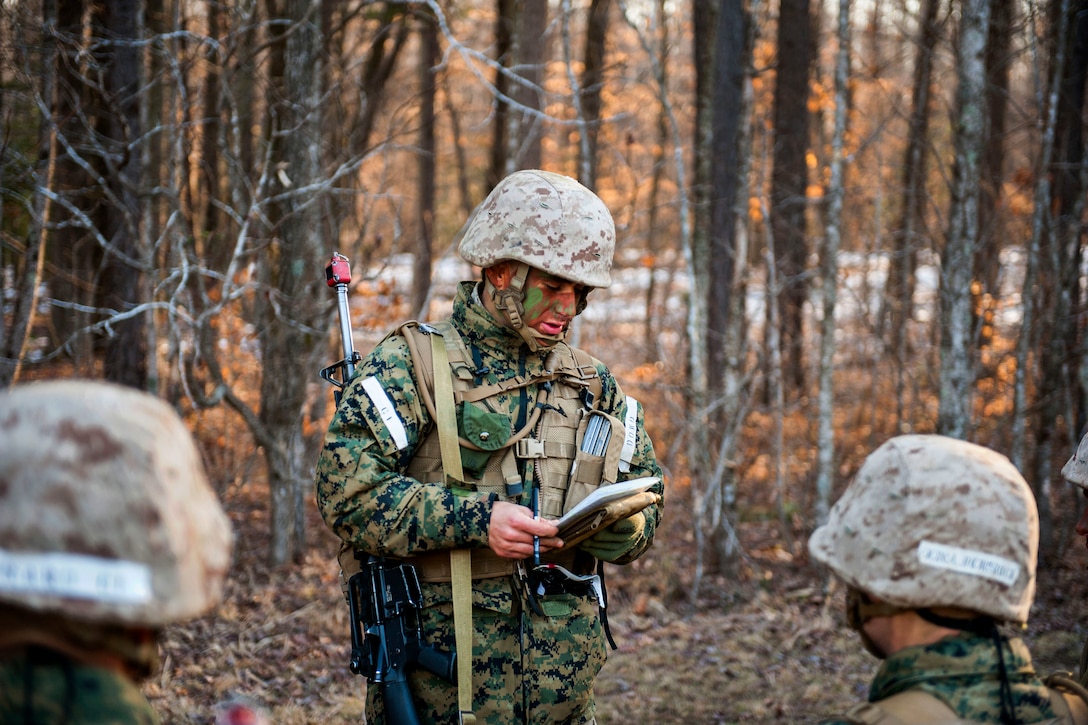 A Marine Corps officer candidate briefs team members before a small-unit leadership evaluation begins at Brown Field on Marine Corps Base Quantico, Va., Feb. 18, 2016. The Marine officer candidates are assigned to Charlie Company, Officer Candidates Class 221. Marine Corps photo by Cpl. Patrick H. Owens
