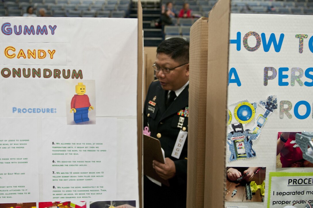 U.S. Army Reserve Master Sgt. Jaunito Bautista, senior maintenance noncommissioned officer in charge, 412th Theater Engineer Command, judges projects at the district science fair at the Vicksburg Auditorium in Vicksburg, Miss., Feb. 23 to 24. (U.S. Army photo by Staff Sgt. Debralee Best)