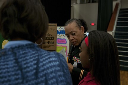 U.S. Army Reserve Chief Warrant Officer 4 Destria Gladney, transportation officer in charge, 412th Theater Engineer Command, listens to a student while judging a project during the district science fair at the Vicksburg Auditorium in Vicksburg, Miss., Feb. 23. (U.S. Army photo by Staff Sgt. Debralee Best)