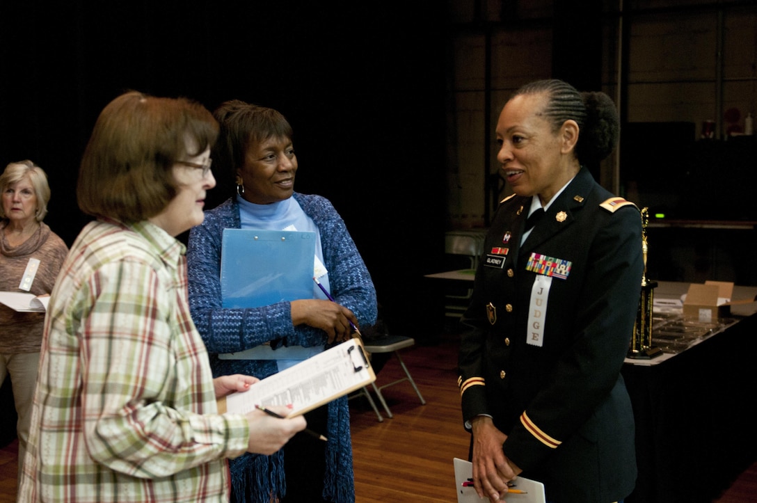 U.S. Army Reserve Chief Warrant Officer 4 Destria Gladney, transportation officer in charge, 412th Theater Engineer Command, speaks with other judges. U.S. Army Reserve Soldiers and civilians with the 412th TEC judged the district science fair at the Vicksburg Auditorium in Vicksburg, Miss., Feb. 23 to 24. (U.S. Army photo by Staff Sgt. Debralee Best)