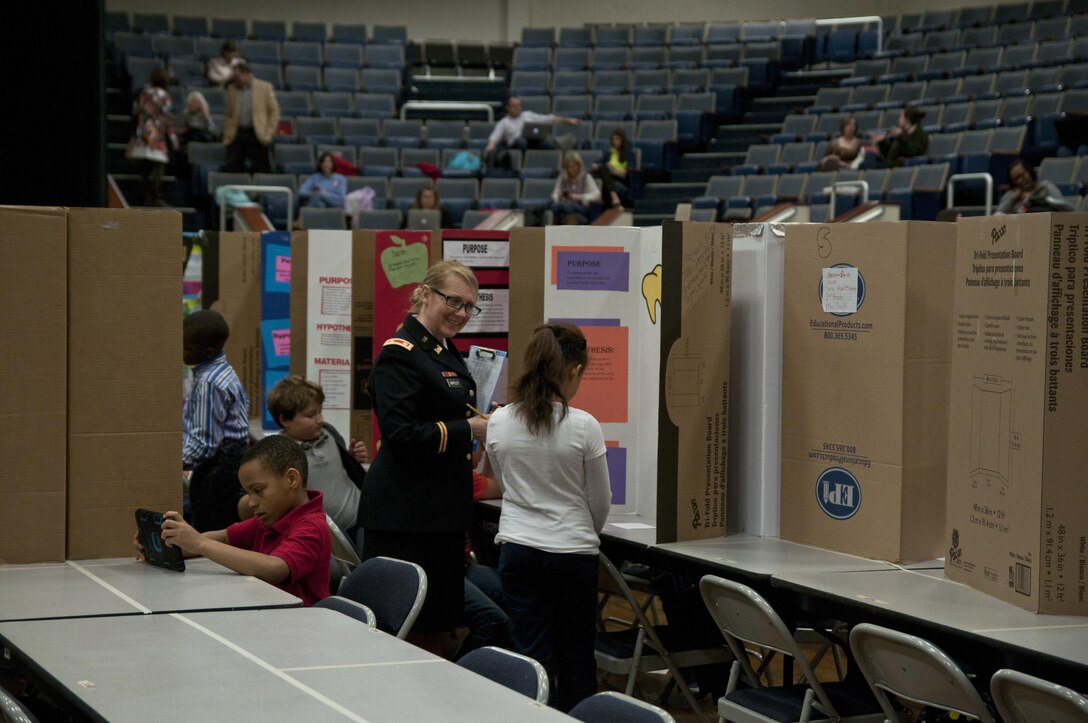 U.S. Army Reserve Maj. Colleen Bartlett, secretary to the general staff, 412th Theater Engineer Command, judges a project during the district science fair at the Vicksburg Auditorium in Vicksburg, Miss., Feb. 24. (U.S. Army photo by Staff Sgt. Debralee Best)