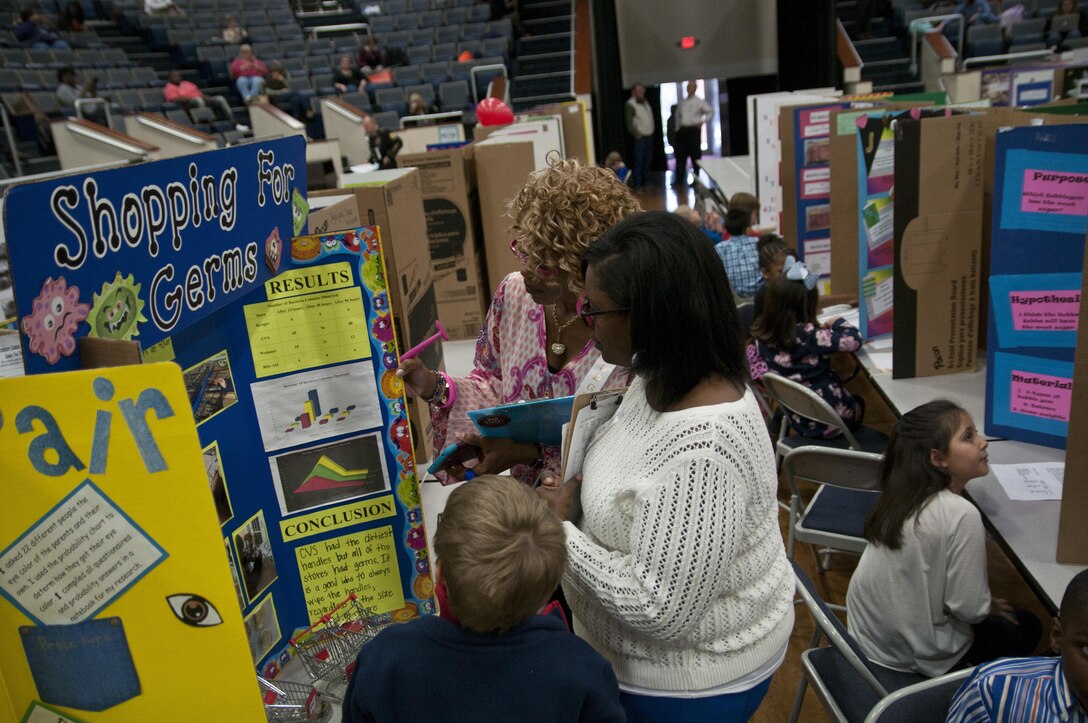 Pleshette Harris, suicide prevention coordinator, 412th Theater Engineer Command, judges a project at the district science fair at the Vicksburg Auditorium in Vicksburg, Miss., Feb. 24. (U.S. Army photo by Staff Sgt. Debralee Best)