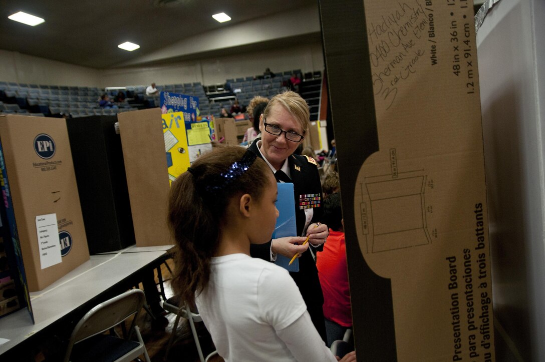 U.S. Army Reserve Maj. Colleen Bartlett, secretary to the general staff, 412th Theater Engineer Command, judges a project during the district science fair at the Vicksburg Auditorium in Vicksburg, Miss., Feb. 24. (U.S. Army photo by Staff Sgt. Debralee Best)