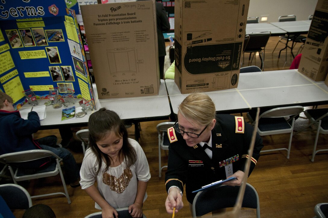 U.S. Army Reserve Maj. Colleen Bartlett, secretary to the general staff, 412th Theater Engineer Command, judges a project during the district science fair at the Vicksburg Auditorium in Vicksburg, Miss., Feb. 24. (U.S. Army photo by Staff Sgt. Debralee Best)