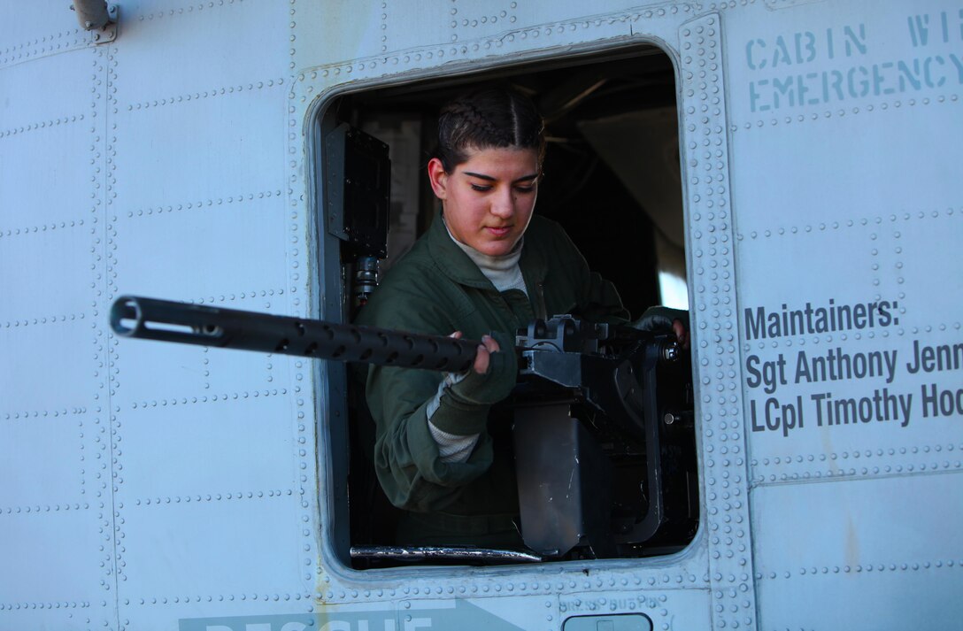 Lance Cpl. Samantha Alaw mounts a .50-caliber machine gun onto a CH-53E Super Stallion during Exercise Eager Response at Marine Corps Air Station Beaufort, S.C., Feb. 25, 2016. During the exercise, Marines trained in events such as casualty evacuation, assault support missions and aerial refueling, proving the 2nd Marine Aircraft Wing with a highly effective combat force. Alaw is a CH-53E crew chief with Marine Heavy Helicopter Squadron 366. (U.S. Marine Corps photo by Pfc. Nicholas P. Baird/Released)