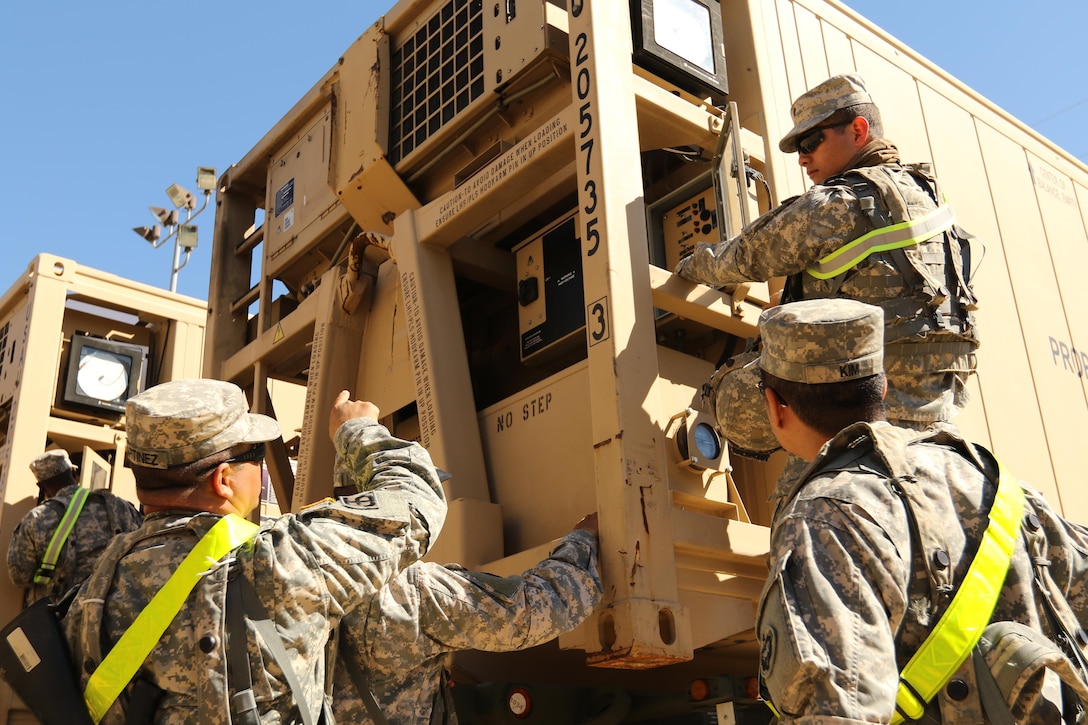 Spc. Robin Trinidad (right), an automated logistics specialist from the 103rd Quartermaster Company in Houston, inspects a cooler Feb. 17, 2016, at Fort Polk, La., used to preserve perishable foods in the field. The Los Angeles native and his Army Reserve company are supporting field exercises during a base field exercise. (U.S. Army photo by Sgt. Brandon Hubbard, 204th PAD)