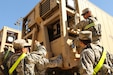 Spc. Robin Trinidad (right), an automated logistics specialist from the 103rd Quartermaster Company in Houston, inspects a cooler Feb. 17, 2016, at Fort Polk, La., used to preserve perishable foods in the field. The Los Angeles native and his Army Reserve company are supporting field exercises during a base field exercise. (U.S. Army photo by Sgt. Brandon Hubbard, 204th PAD)