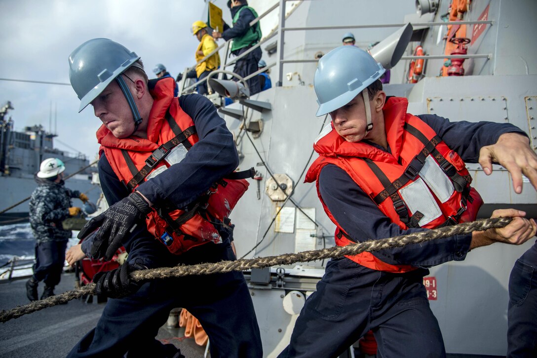 Sailors aboard the USS Chung-Hoon haul in a line during a replenishment at sea with the USNS Rainier in the Philippine Sea, Feb. 22, 2016. The Chung-Hoon is on a regularly scheduled deployment in the U.S. 7th Fleet area of responsibility. Navy photo by Petty Officer 2nd Class Marcus L. Stanley