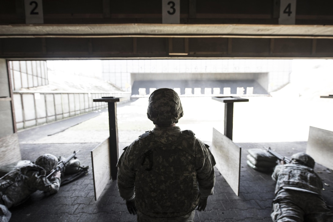Army Staff Sgt. Esteban Arenas waits for fellow soldiers to zero out the sights on their M16 rifles on a military shooting range in Landstuhl, Germany, Feb. 25, 2016. Soldiers wore personal protective equipment during the training to help prevent injuries such as traumatic brain injury. DoD photo by Air Force Tech. Sgt. Brian Kimball
