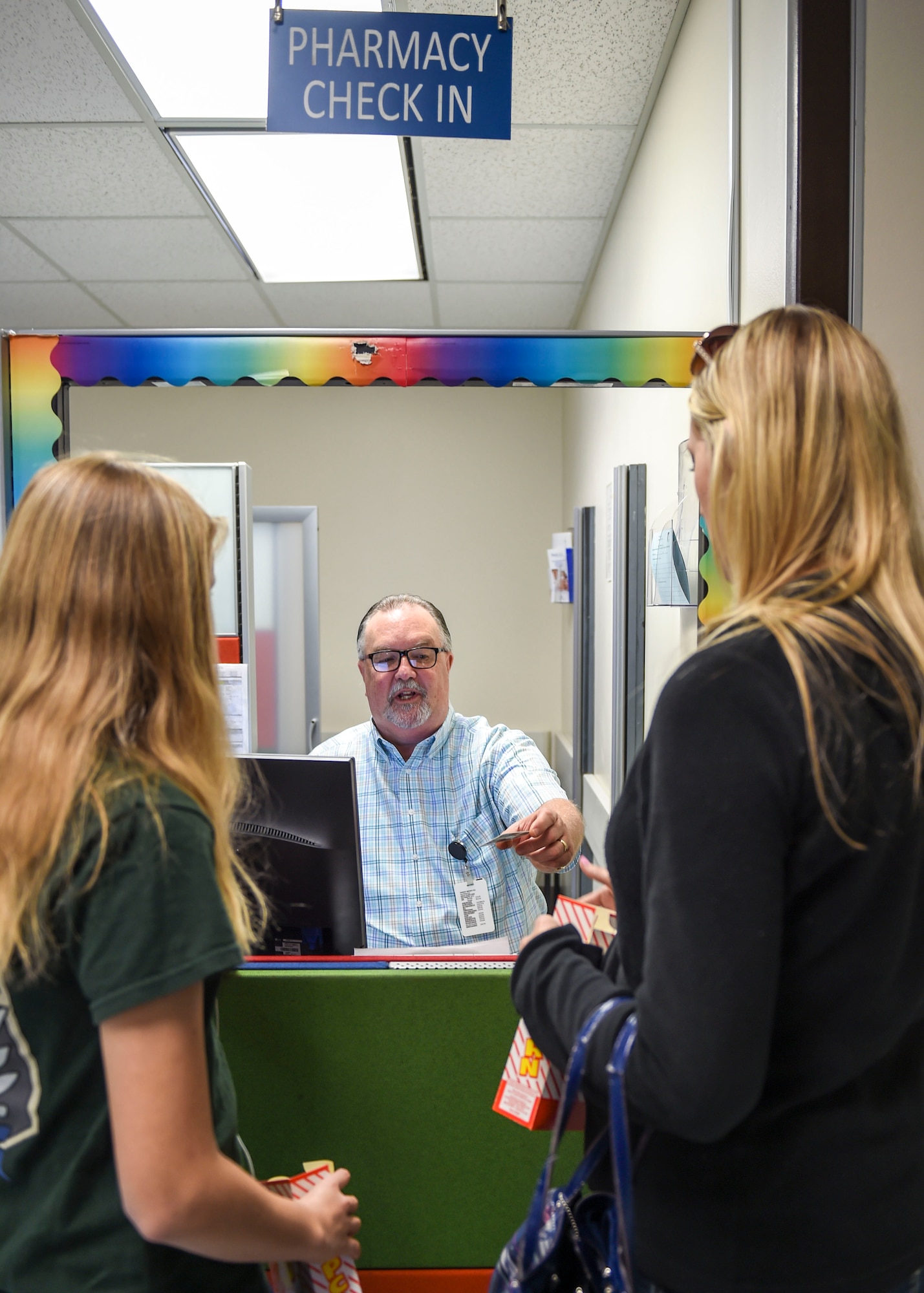 Walter Hughen, pharmacy technician, checks in patients at the pediatric pharmacy Feb. 12, 2016, at the Wilford Hall Ambulatory Surgical Center, Joint Base San Antonio-Lackland. The embedded pharmacy technicians have helped decrease prescription processing times by 48 percent. (U.S. Air Force photo/Staff Sgt. Chelsea Browning)