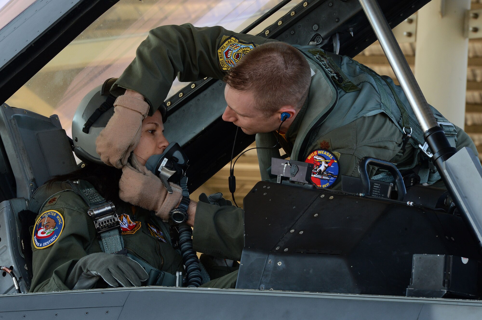U.S. Air Force Maj. Brett Shilling, 20th Fighter Wing chief of plans, secures Janina Shilling, his wife, into an F-16DM Fighting Falcon in preparation for a spouse taxi at Shaw Air Force Base, S.C., Feb. 26, 2016. Shilling took advantage of the opportunity to drive his wife down Shaw’s runway in a two-seated F-16 to give her a better idea of what he does on  daily basis. (U.S. Air Force photo by Senior Airman Zade Vadnais)