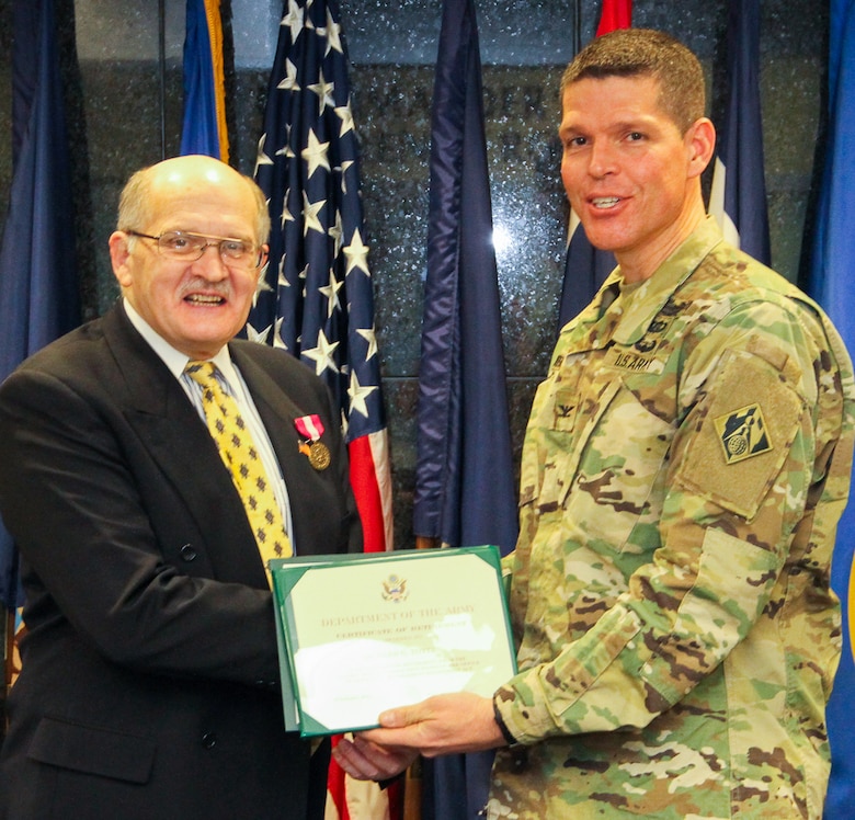 Its official, Rick Totten is handed his retirement certificate from Colonel John Henderson and he is out the door to retirement, effective February 29, 2016.