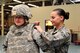 Senior Airman Anna Sherman, 56th Logistics Readiness Squadron individual protective equipment journeyman, practices fitting an Improved Outer Tactical Vest on Senior Airman Georgette Moore, 56th LRS IPE journeyman, Feb. 25, 2016 at Luke Air Force Base, Ariz. IPE Airmen issue mobility oriented protection gear, outer tactical vests, helmets and more. (U.S. Air Force photo by Staff Sgt. Grace Lee)