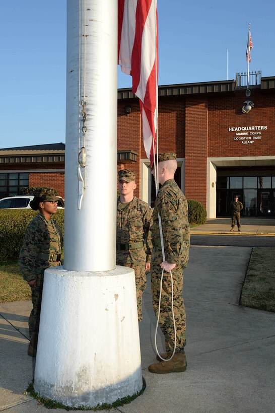 Marines prepare to raise the American flag during Morning Colors in front of Building 3500, headquarters for Marine Corps Logistics Base Albany, March 1.  March 1 marks the 64th anniversary of Marine Corps Logistics Base Albany.  