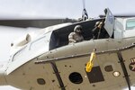 (Left to right) Tech. Sgt. Michael Wright, 459th Airlift Squadron flight engineer and Tech. Sgt. Christopher Pound, 36th Rescue Squadron special missions aviator evaluator, perform hoist training at Yokota Air Base, Japan, Feb. 22, 2016. The 459th AS recently improved their search and rescue capabilities by outfitting two Hueys with new rescue hoists. Previously, without the hoist, conducting rescues in small, tight areas wasn’t feasible. Now, 459th AS aircrew can conduct any type of search and rescue scenario throughout the Kanto Plains. 