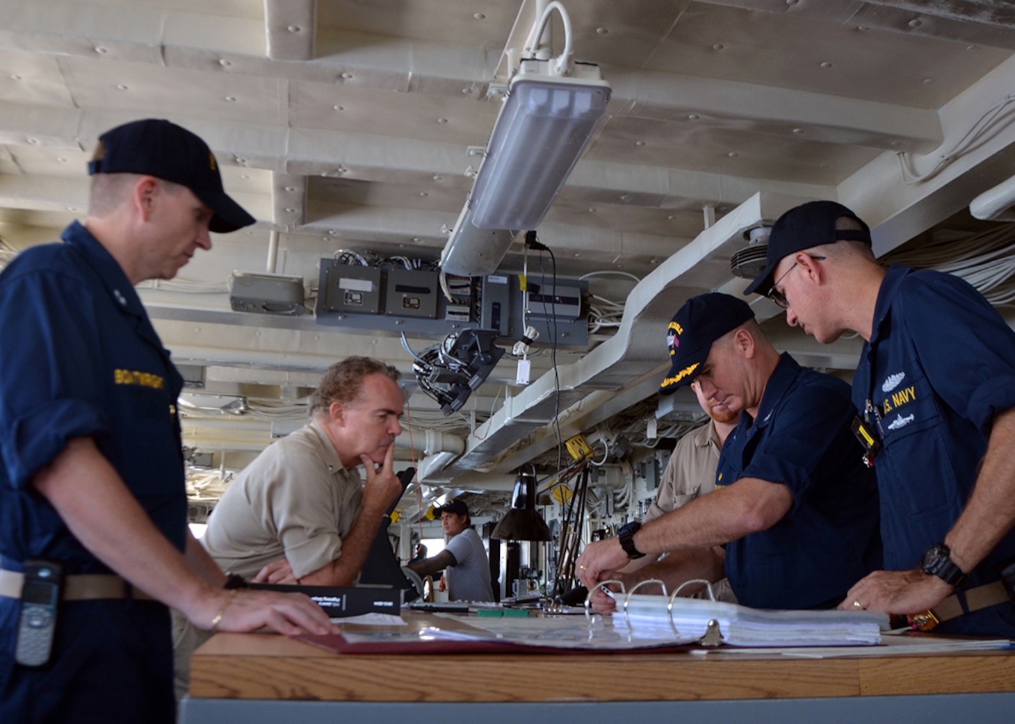 140403-N-AY759-001
PACIFIC OCEAN (April 3, 2014)  Capt. Mark Benjamin, center right, commanding officer of the submarine tender USS Frank Cable (AS 40), approves the course Frank Cable will take to rendezvous with the Military Sealift Command dry cargo and ammunition ship USNS Cesar Chavez (T-AKE 14) to conduct an underway replenishment. This is the first underway replenishment for Frank Cable in ten years and will take on 280,000 gallons of fuel from Cesar Chavez. Frank Cable, forward deployed to the island of Guam, conducts maintenance and support of submarines and surface vessels deployed in the U.S. 7th Fleet area of responsibility and is on a scheduled underway period. (U.S. Navy photo by Senior Chief Mass Communication Specialist Jason Morris/Released)
