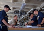 140403-N-AY759-001
PACIFIC OCEAN (April 3, 2014)  Capt. Mark Benjamin, center right, commanding officer of the submarine tender USS Frank Cable (AS 40), approves the course Frank Cable will take to rendezvous with the Military Sealift Command dry cargo and ammunition ship USNS Cesar Chavez (T-AKE 14) to conduct an underway replenishment. This is the first underway replenishment for Frank Cable in ten years and will take on 280,000 gallons of fuel from Cesar Chavez. Frank Cable, forward deployed to the island of Guam, conducts maintenance and support of submarines and surface vessels deployed in the U.S. 7th Fleet area of responsibility and is on a scheduled underway period. (U.S. Navy photo by Senior Chief Mass Communication Specialist Jason Morris/Released)
