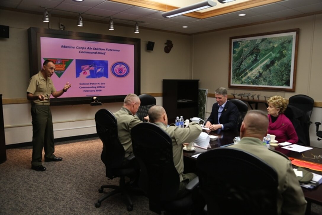 Col. Peter Lee, left, talks to Madeline Bordallo, far right, and Rob Wittman, third from right, about facilities and maintenance Feb. 16 on Marine Corps Air Station Futenma, Okinawa, Japan. Bordallo and Wittman visited the air station to talk with the leadership from III Marine Expeditionary Force and Marine Corps Installations Pacific about the current state of MCAS Futenma and the ongoing construction of the Futenma Replacement Facility. Lee is the commanding officer of MCAS Futenma, Marine Corps Installations Pacific. Bordalla is a U.S. Representative for Guam and a member of the House Armed Services Committee on Readiness. Wittman is a U.S. Representative for Virginia and the chairman of the House Armed Services Committee on Readiness. 
