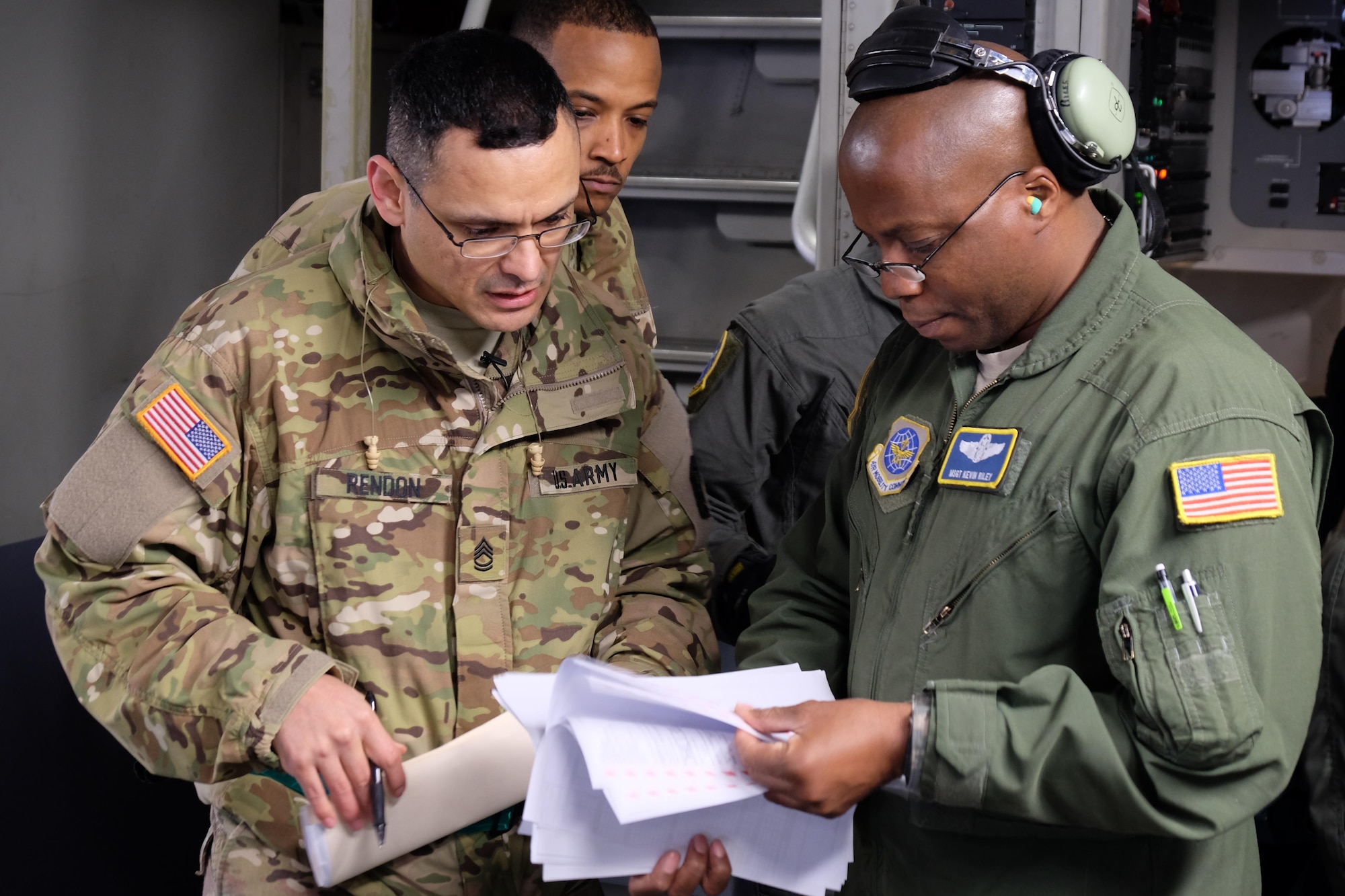 Sergeant 1st Class Joaquin Rendon and Master Sgt. Kevin Riley review the load plan during joint partnered movement control operations with French Air Force members Feb. 22, 2016, in support of United States Africa Command’s Operation Echo Casemate resupply mission to French military forces deployed to the Central African Republic. Riley is an instructor load master assigned to 14th Air Squadron Joint Base Charleston Air Force Base, South Carolina. (Photo by Sgt. 1st Class Matthew Chlosta)