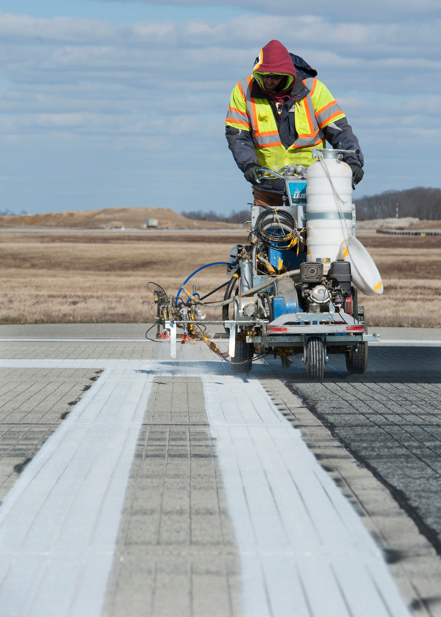 White paint is sprayed onto Runway 14-32 by a Mullen’s Markings crew as part of an ongoing runway construction project Feb. 26, 2016, at Dover Air Force Base, Del. Runway 14-32 is being temporarily shortened due to an ongoing construction project on its intersection with Runway 01-19. (U.S. Air Force photo/Senior Airman Zachary Cacicia)