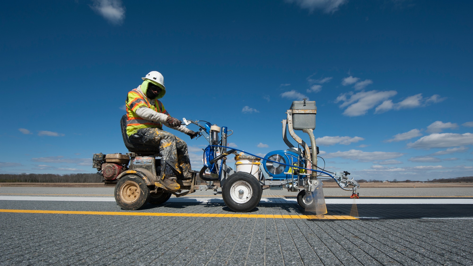 A crew from Mullen’s Markings sprays yellow paint onto Runway 14-32 Feb. 26, 2016, at Dover Air Force Base, Del. Dover AFB's airfield temporarily closed from Feb. 24 to March 1, 2016, to permit crews to remove and repaint airfield markings and reposition and adjust airfield lights. This will allow Runway 14-32 to be shortened for operations during this phase of the ongoing Runway 01-19 construction project.  (U.S. Air Force photo/Senior Airman Zachary Cacicia)