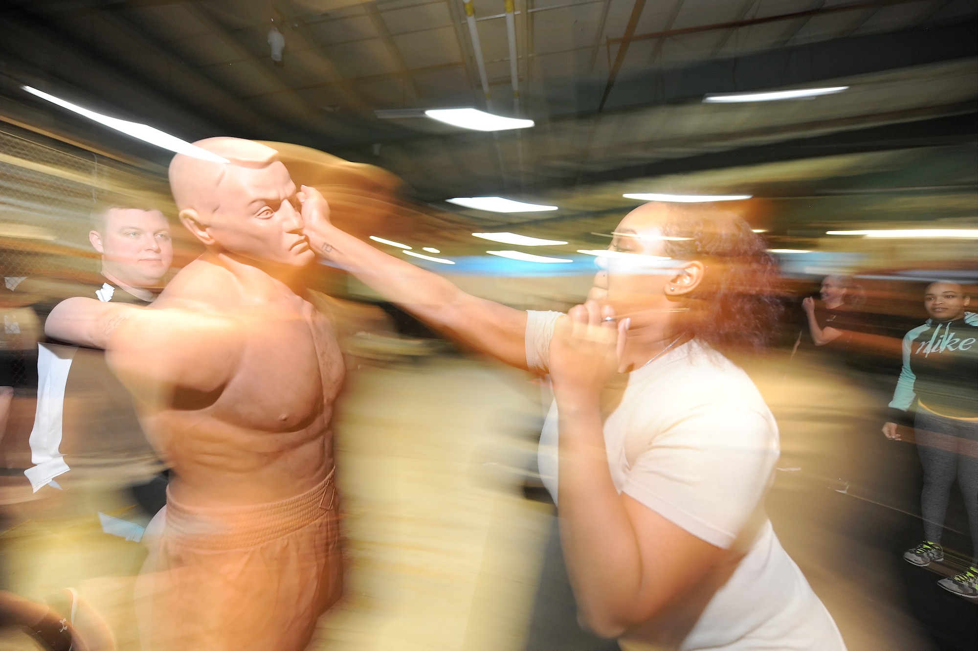 Senior Airmen Charigail Charlton, 436th Logistics Readiness Squadron logistics planner, makes contact with the face of a training mannequin while Staff Sgt. Bryan Miller, 436th Security Forces Squadron patrolman, monitors the training during the 436th SFS Safety and Self-Defense Strategy program Feb. 26, 2016, at Dover Air Force Base, Del. The course provided safety tips and self-defense training to military and dependent women by security forces personnel. (U.S. Air Force photo/Greg L. Davis)