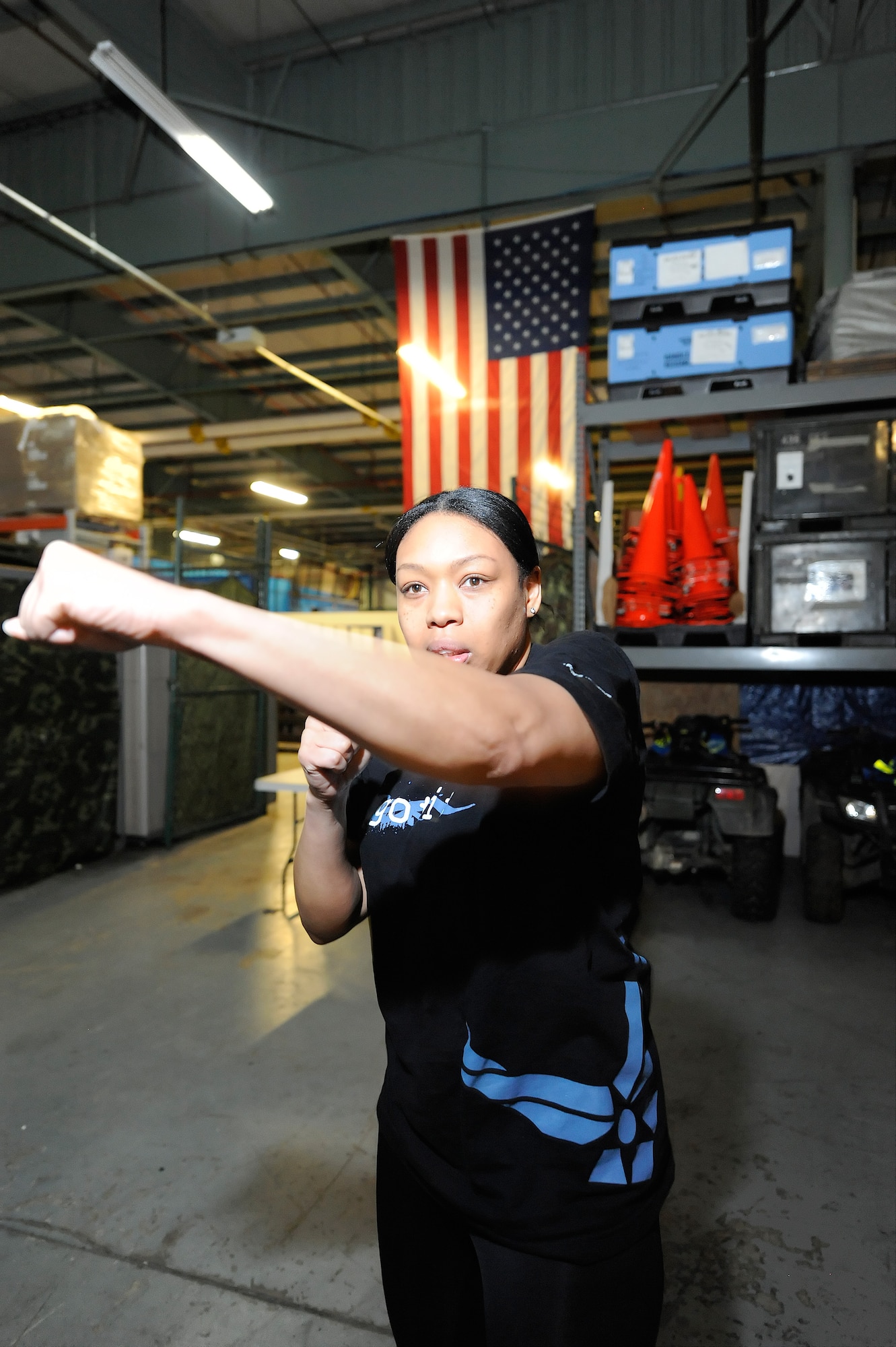 Tech. Sgt. Taisha Moore, 709th Airlift Squadron resource manager, practices throwing a punch during the 436th Security Forces Squadron Safety and Self-Defense Strategy program Feb. 26, 2016, at Dover Air Force Base, Del. The training took place in the facility primarily used by the SFS to train Raven personnel. (U.S. Air Force photo/Greg L. Davis)