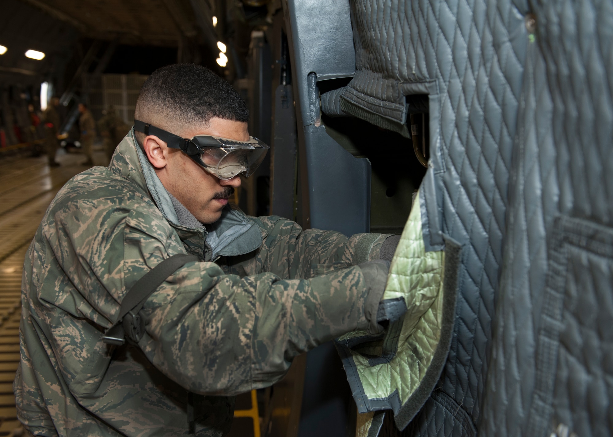 Airman 1st Class Langdon Hammond, 436th Aircraft Maintenance Squadron aircraft hydraulic systems journeyman, performs maintenance inside a C-5M Super Galaxy Feb. 24, 2016, at Joint Base McGuire-Dix-Lakehurst, N.J. Hammond is one of 163 Dover Airmen who is on temporary duty at the joint base to perform maintenance. (U.S. Air Force photo/Senior Airman Zachary Cacicia)