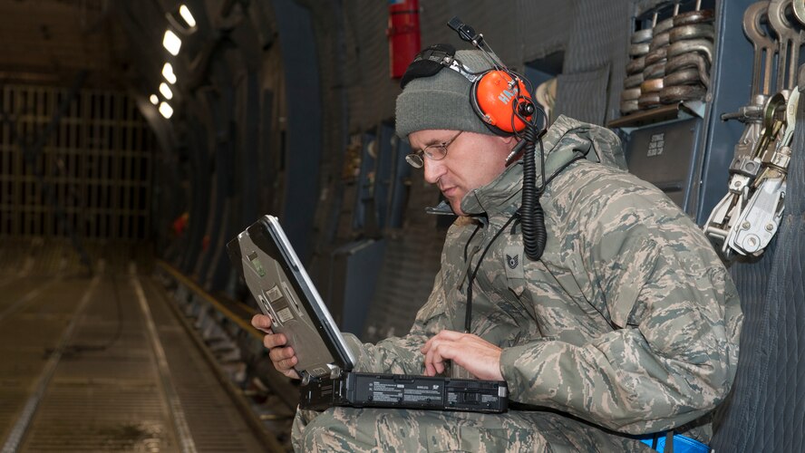 Tech. Sgt. Jeremy Hase, 436th Maintenance Squadron repair and reclamation craftsman, reviews maintenance procedures inside a C-5M Super Galaxy Feb. 24, 2016, at Joint Base McGuire-Dix-Lakehurst, N.J. Team Dover maintainers will be responsible for maintaining up to eight C-5s on the ground at a time. (U.S. Air Force photo/Senior Airman Zachary Cacicia)