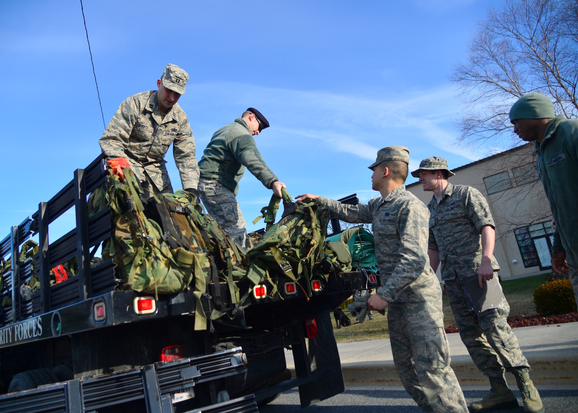 Members of the 436th Security Forces Squadron pass out 30-pound ruck sacks to participants of the 436th SFS 17th Annual Korean War Ruck March Feb. 27, 2016, at Dover Air Force Base, Del. All participants were outfitted with a 30-pound ruck sack and were required to be in military or tactical clothing and combat boots. (U.S. Air Force photo/Tech. Sgt. Elizabeth Morris)