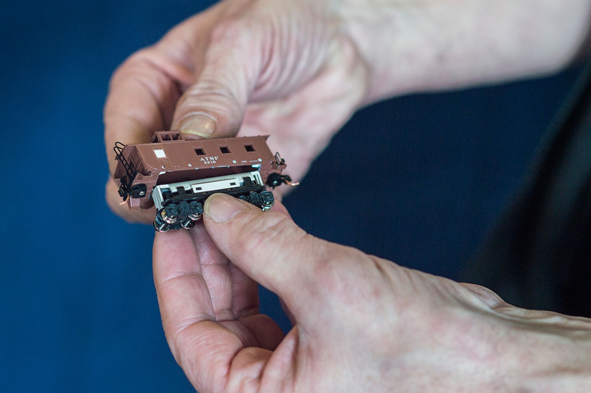 U.S. Air Force veteran Fred Wing, takes apart an N gauge model train at the Alaska Railroad Corporation, passenger depot as the Military Society of Model Railroad Engineers Club puts on a display for the Fur Rendezvous Winter Festival, Feb. 23, 2016.  According to their website, Fur Rendezvous Winter Festival, known locally as Fur Rondy, is the nation's premier winter festival. Since 1935, Fur Rondy has proudly represented the pioneering spirit of Alaskans, offering wild and wacky fun for all ages. (U.S. Air Force photo by Senior Airman James Richardson)