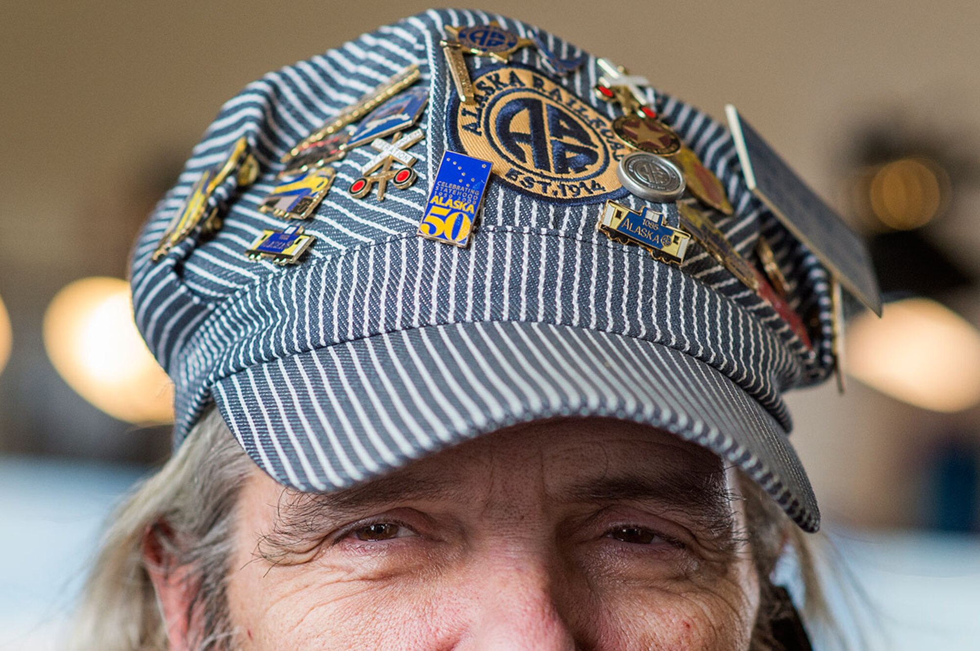 U.S. Air Force veteran Fred Wing, poses for a portrait at the Alaska Railroad Corporation, passenger depot as the Military Society of Model Railroad Engineers Club puts on a display for the Fur Rendezvous Winter Festival, Feb. 23, 2016.  According to their website, Fur Rendezvous Winter Festival, known locally as Fur Rondy, is the nation's premier winter festival. Since 1935, Fur Rondy has proudly represented the pioneering spirit of Alaskans, offering wild and wacky fun for all ages. (U.S. Air Force photo by Senior Airman James Richardson)
