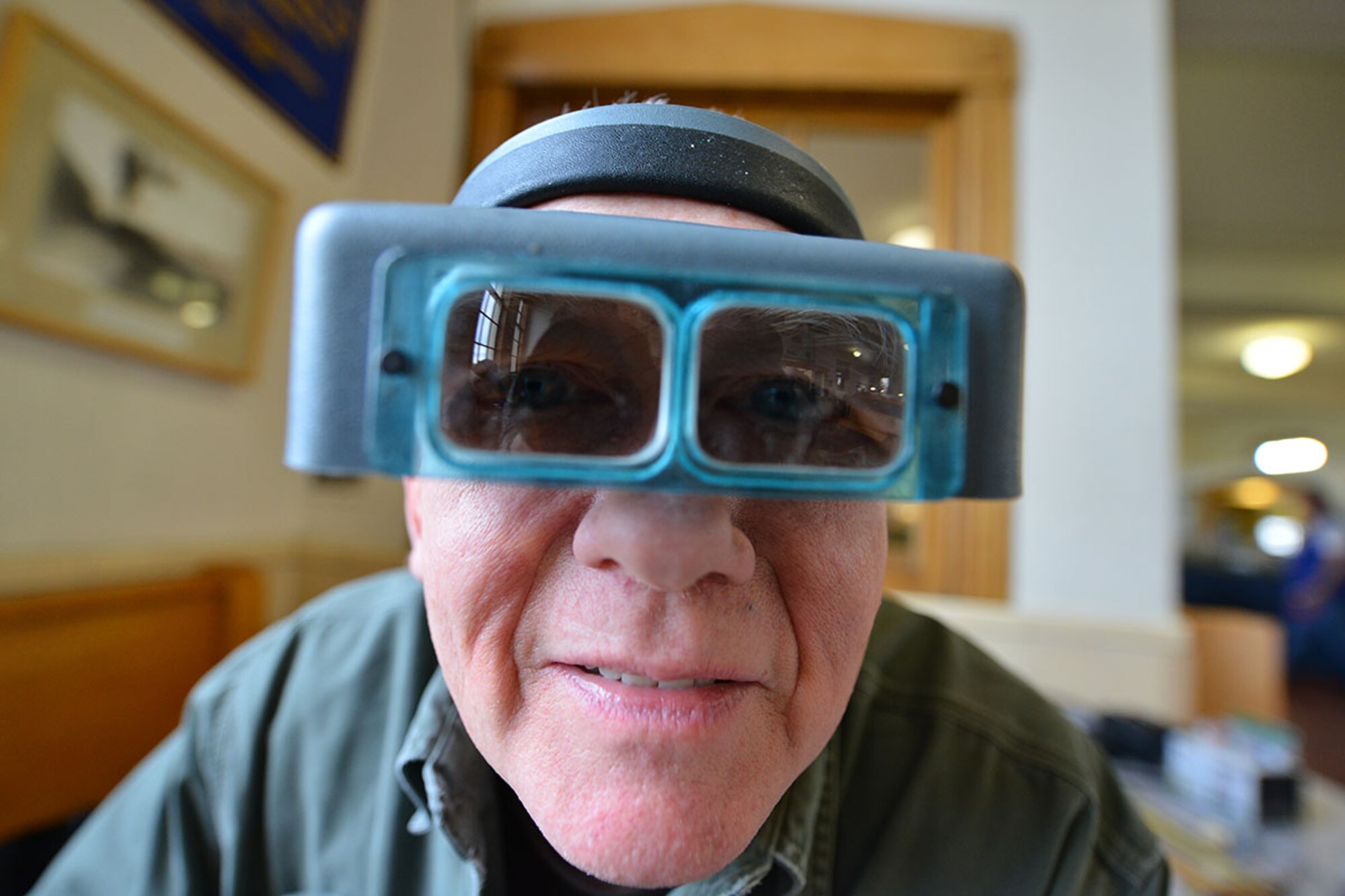 U.S. Army veteran, Mike Philo, wears a magnifying headset for building model trains to be used in the Military Society of Model Railroad Engineers' display at the 2016 Fur Rendezvous festival. The trains are so detailed, Philo glues the under workings to the bottom of each of the box cars. (U.S. Air Force photo by Airman 1st Class Kyle Johnson)