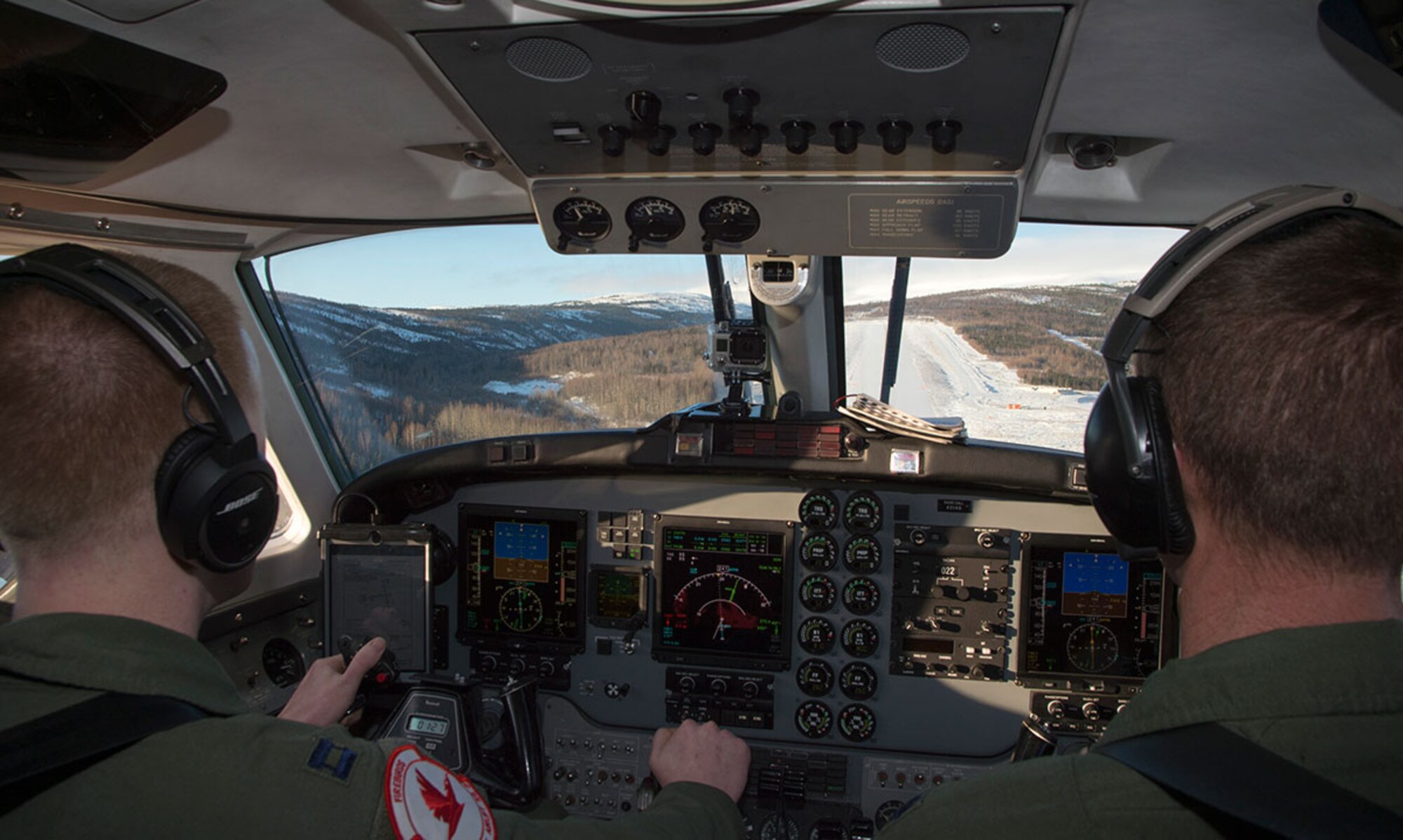 Air Force Lt. Col. Blake Johnson (right) guides Capt. David Blessinger, left, landing at Indian Mountain Air Force Station near Hughes, Alaska, Feb. 23, 2016. Indian Mountain AFS in one the seven long-range radar sites the 517th Airlift Squadron fly to, providing operational support airlift to remote locations. Johnson and Blessinger are both assigned to the 517th AS. (U.S. Air Force photo by Staff Sgt. Sheila deVera)