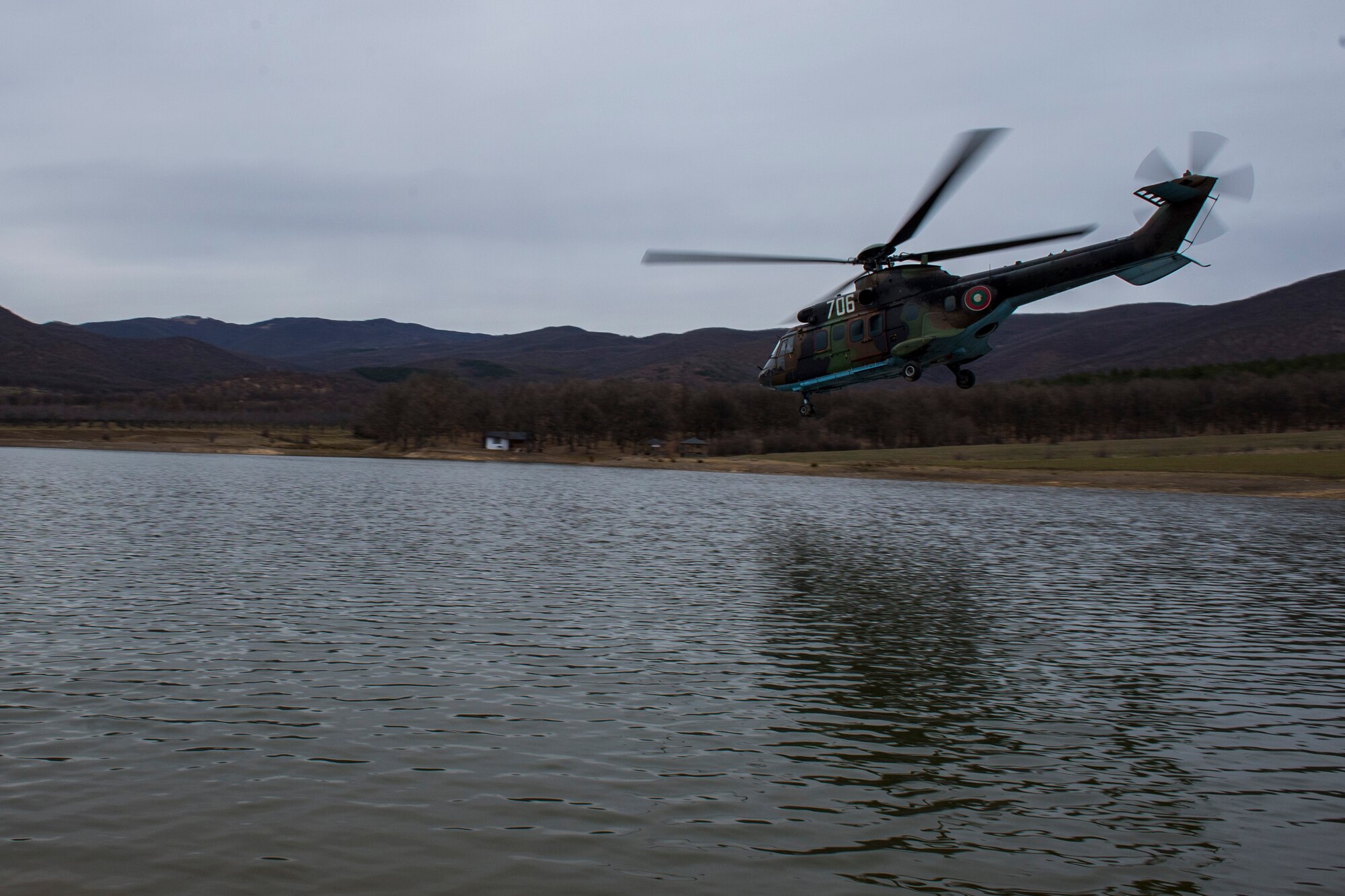 PLOVDIV, Bulgaria - A Bulgarian Cougar military helicopter flies over a body of water during combat search and rescue training near Plovdiv, Bulgaria, Feb. 11, 2016. The helicopter was protected by 74th Expeditionary Fighter Squadron A-10C Thunderbolt II aircraft during the training. (U.S. Air Force photo by Airman 1st Class Luke Kitterman/Released)