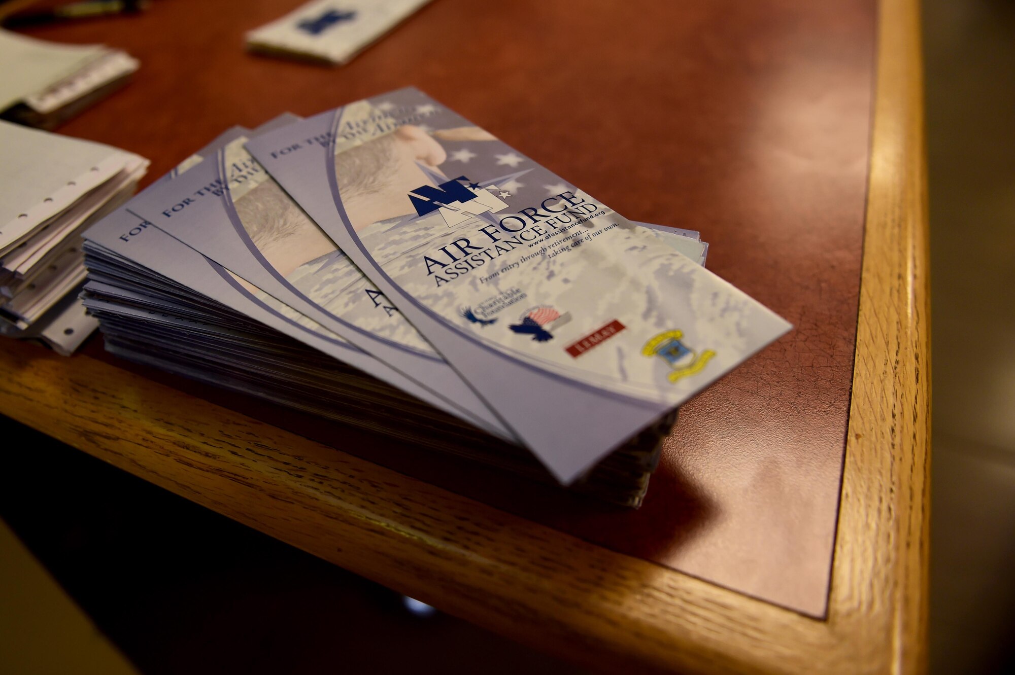 Air Force Assistance Fund information pamphlets are placed on the welcome table Mar. 1, 2016, during the kickoff breakfast at the Panther Den on Buckley Air Force Base, Colo. AFAF provides emergency, educational and financial support for Air Force families through donations from events such as the kickoff breakfast. (U.S. Air Force photo by Airman 1st Class Gabrielle Spradling/Released)