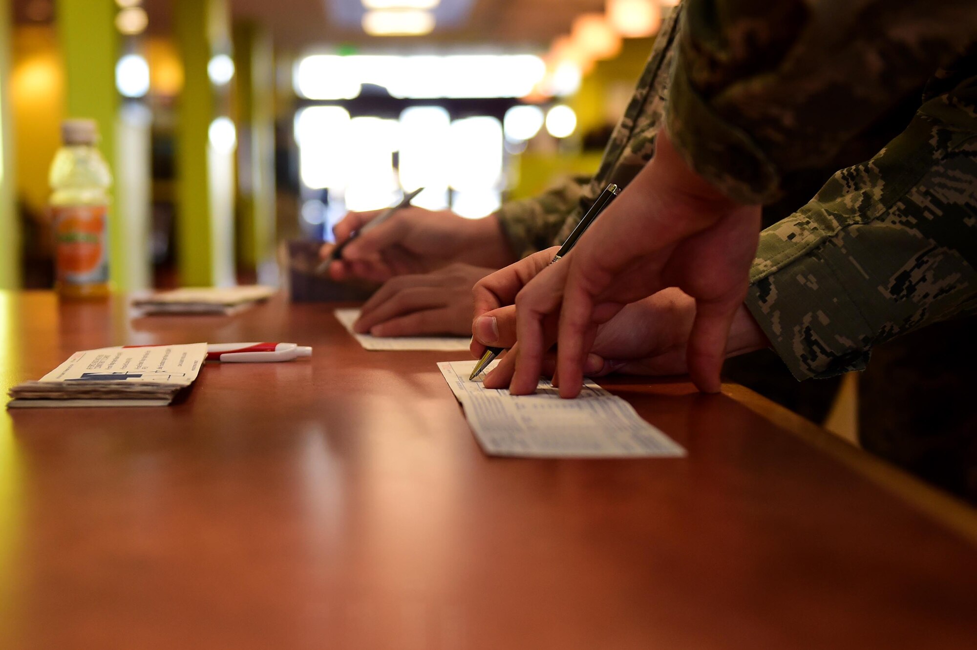 Buckley Airmen fill out Air Force Assistance Fund donation forms Mar. 1, 2016, at the Panther Den on Buckley Air Force Base, Colo. AFAF is an annual effort to help Air Force families in need of emergency, educational or financial assistance. (U.S. Air Force photo by Airman 1st Class Gabrielle Spradling/Released)