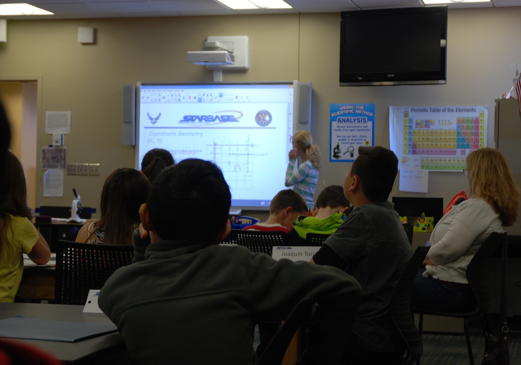 PETERSON AIR FORCE BASE, Colo. – Bridgette McAllister, one of the STARBASE Academy instructors, teaches fifth-graders from Madison Elementary School about plotting points on a grid. The students would use the information to work in teams building circuit boards during a STARBASE session. (U.S. Air Force Photo by Dave Smith)