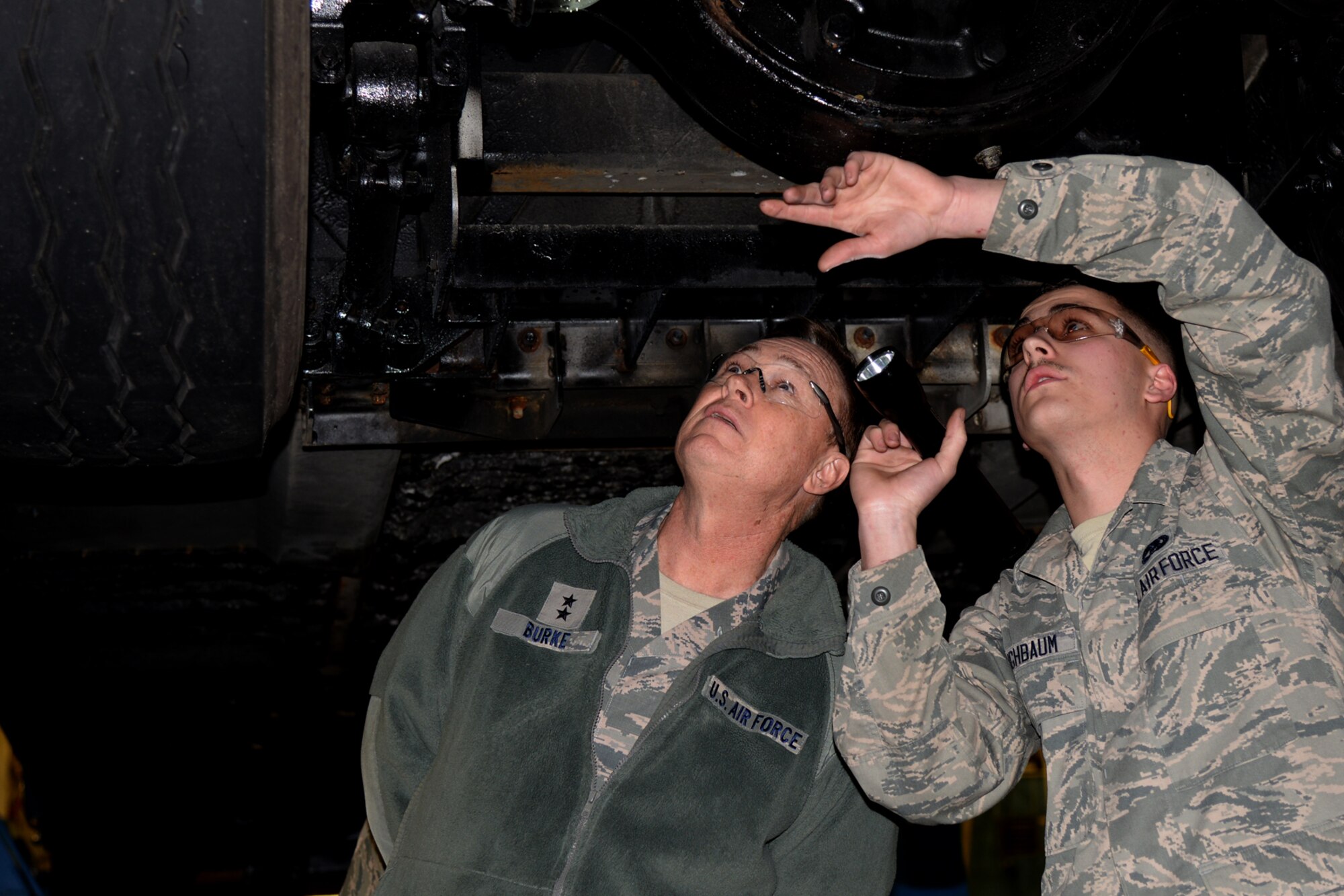 Senior Airman Tyler Laughbaum, 11th Logistics Readiness Squadron, briefs Air Force District of Washington Commander Maj. Gen. Darryl Burke on Service Life Enhancement Program upgrades to the Coach Bus fleet on Joint Base Andrews, Md., Feb. 23, 2016. AFDW partnered with the 11th LRS to ensure funding was available to repair the buses that provide transportation for the Air Force Band and Honor Guard. (U.S. Air force photo/Tech. Sgt. Matt Davis)