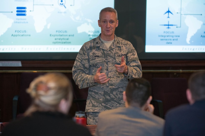Col. Bruce Lyman, Distributed Common Ground System Modernization chief, speaks to members of the Revolutionary Acquisition Techniques Procedures and Collaboration group at the conference center at Hanscom Air Force Base, Mass., Feb. 25. One of the topics Lyman discussed was ways to bring new technology into various intelligence, surveillance and reconnaissance systems and rapidly deploy it to the field. The RATPAC is a network of junior Air Force acquirers who discuss and share knowledge and experience to improve acquisition program execution. (U.S. Air Force photo by Jerry Saslav)