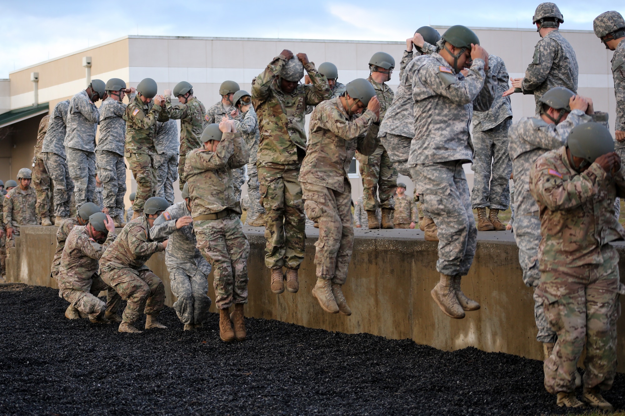 Green Berets and soldiers assigned to the 7th Special Forces Group (Airborne) practice their parachute landing falls while conducting pre-jump safety training in preparation for conducting a static-line parachute jump Feb. 23.  The soldiers jumped from Army UH-60 Blackhawk helicopters onto an Eglin Air Force Base drop zone to maintain their airborne proficiency.  (U.S. Army photo/Sgt. Sara Wakai)
