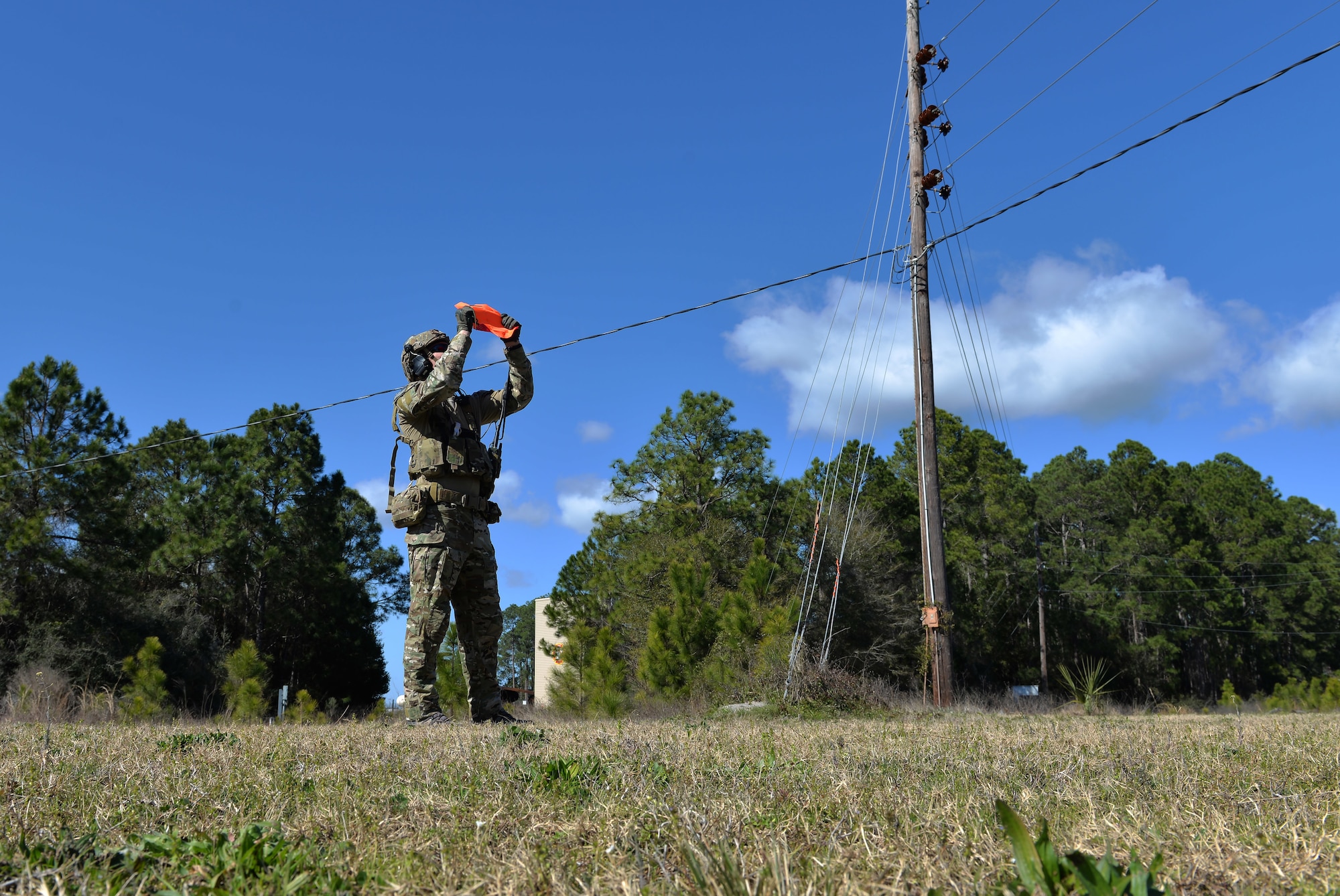 An Army Ranger from the 75th Ranger Regiment, 3rd Ranger Battalion signals an aircraft to his team’s position at Hurlburt Field, Fla., Feb. 11. During this exercise, Rangers radioed coordinates to F-35A Lightning II pilots to simulate close air support. (U.S. Air Force photo/Senior Airman Andrea Posey)