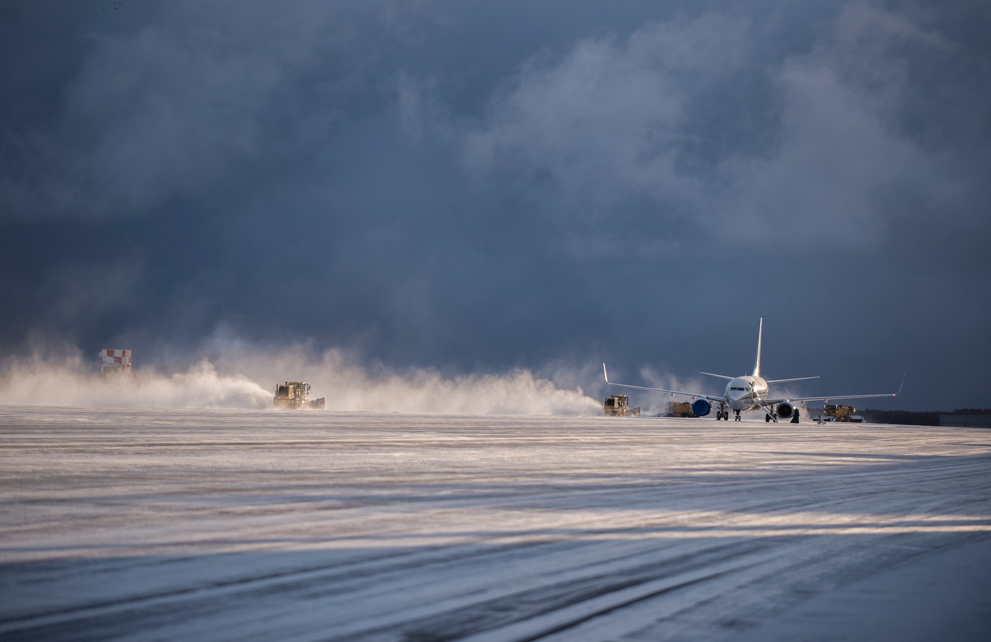 Air blast sweepers from the 35th Civil Engineer Squadron clear snow on the runway at Misawa Air Base, Japan, Feb. 24, 2016. Every year Misawa gets struck with heavy snow from Mid-November to the end of March, totaling approximately 160 inches annual, making the base one of the snowiest in the Air Force. (U.S. Air Force photo by Senior Airman Brittany A. Chase)
