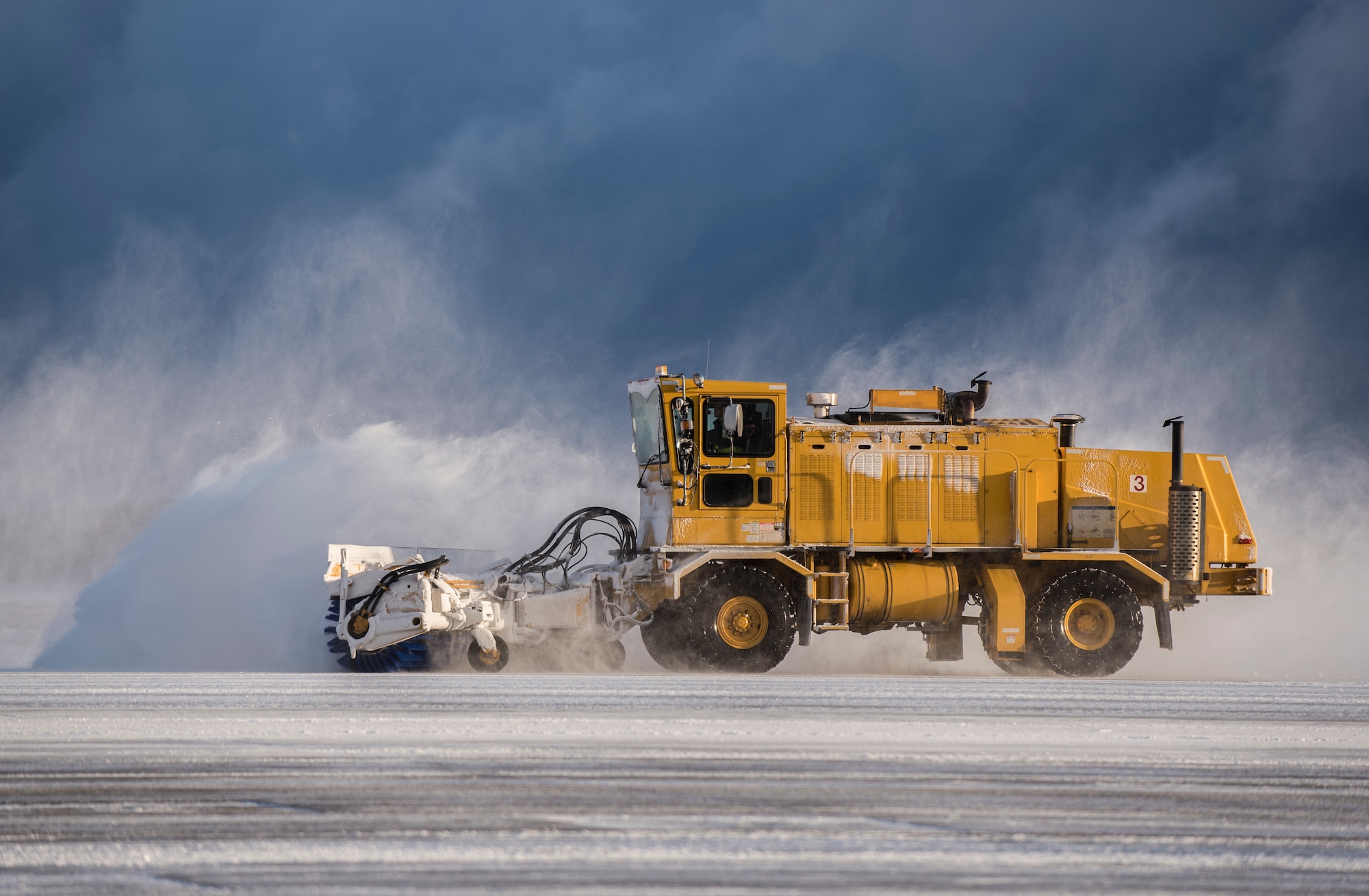 A member from 35th Civil Engineer Squadron operates an air blast sweeper on the runway at Misawa Air Base, Japan, Feb. 24, 2016. These 35th CES Airmen make sure the flying mission can be carried out and the base populous is able to safely commute from point A to point B during the winter. (U.S. Air Force photo by Senior Airman Brittany A. Chase)