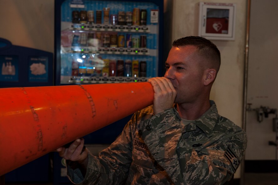 U.S. Air Force Staff Sgt. Holland Bankston, 18th Component Maintenance Squadron quality assurance inspector, encourages spouses as they go through challenges during Team Kadena Spouses’ Amazing Race Feb. 24, 2016, at Kadena Air Base, Japan. Bankston’s job during the race was to sign off on competitors’ paperwork when they completed tasks, allowing them to progress onto the next challenge. (U.S. Air Force photo by Airman 1st Class Lynette M. Rolen)