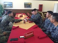 Japanese Air Self Defense Force Staff Sgt. Shinya Nishida, right, accepts a momento from U.S. Marine Corps Staff Sgt. Jorge M. Guinta, left, at the professional military exchange program farewell luncheon February 25 at the Habu Pit Officers’ Club on Marine Corps Air Station Futenma, Okinawa, Japan. The professional military exchange program benefits JASDF and Marines by providing first-hand insight to the daily routines and responsibilities of each service, according to Nishida. The experience and knowledge gained through the program establishes better understanding and communication. Nishida is a flight plan dispatcher with the JASDF. Guinta is the flight planning chief and staff non-commissioned officer in charge of base operations, Headquarters and Headquarters Squadron, MCAS Futenma, Marine Corps Installations Pacific-Marine Corps Base Camp Butler, Japan, and Cranston, RI. native. (U.S. Marine Corps Photo by Cpl. Brittany A. James/Released)